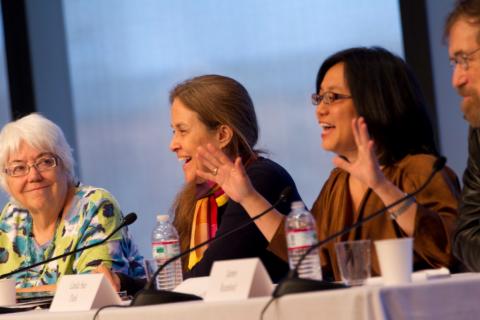 Authors Alma Flor Ada, Naomi Shihab Nye, Linda Sue Park, and James Rumford laughing together at the 2011 Crossing Borders conference authors' panel.