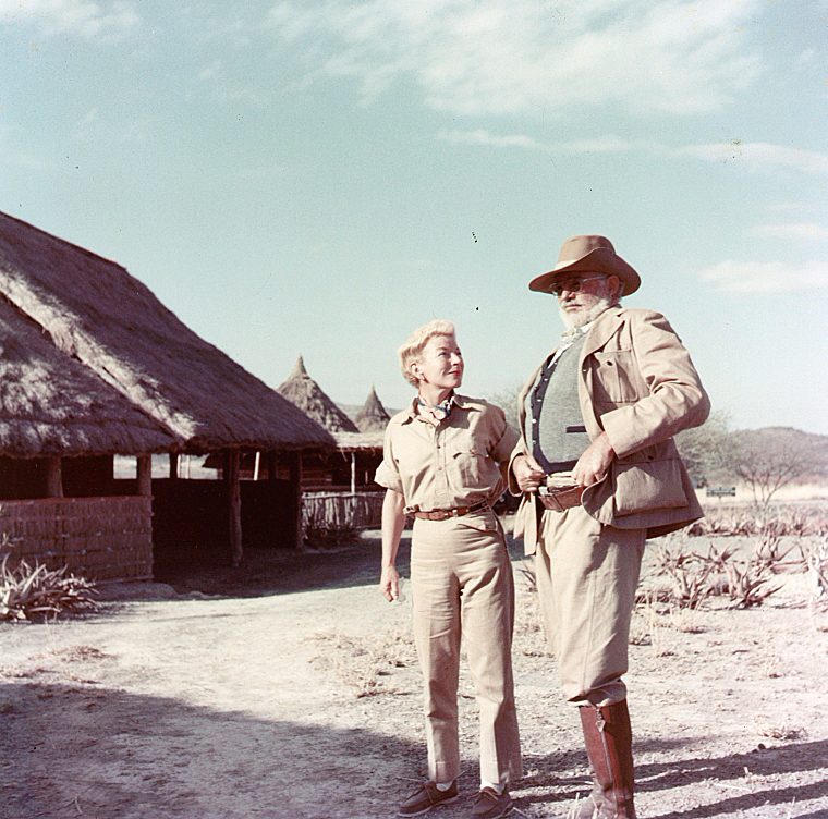 EH-C00542T Ernest and Mary Hemingway near huts while on safari in Africa, circa 1953-1954.