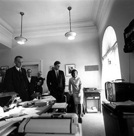JFKWHP-ST-116-9-61. President John F. Kennedy and others watch television coverage of the lift-off of astronaut Commander Alan B. Shepard, Jr. aboard "Freedom 7," on the first US manned sub-orbital flight, 5 May 1961